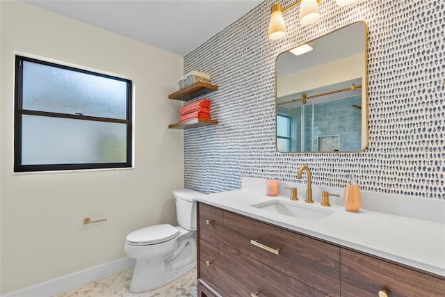 bathroom with a shower with door, vanity, and toilet