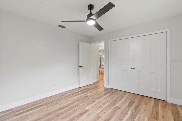 unfurnished bedroom featuring a closet, ceiling fan, and light hardwood / wood-style flooring