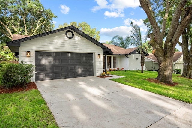 single story home featuring a garage and a front yard