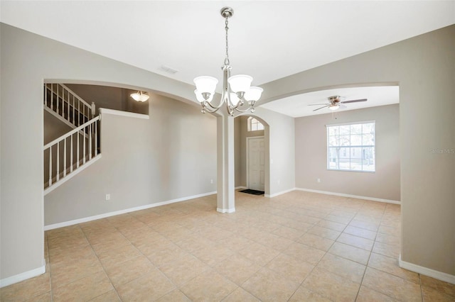 tiled empty room featuring ceiling fan with notable chandelier