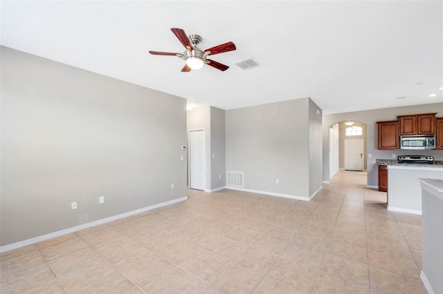 unfurnished living room with ceiling fan and light tile patterned flooring