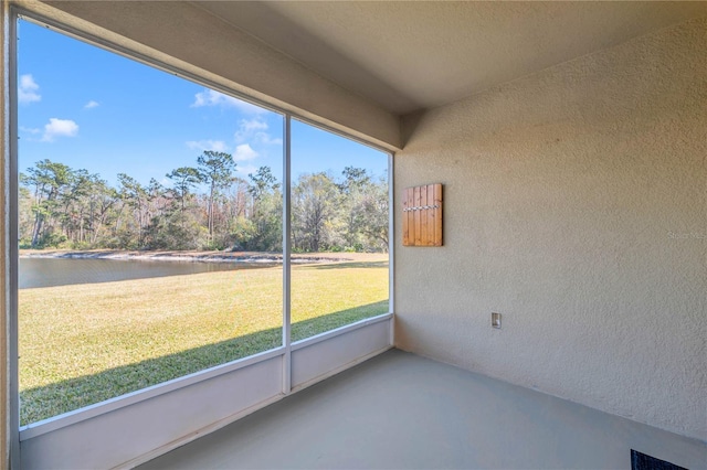 unfurnished sunroom featuring a water view