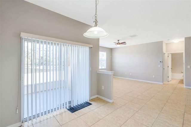 spare room with ceiling fan and light tile patterned floors