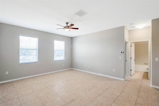 unfurnished room with light tile patterned floors and ceiling fan