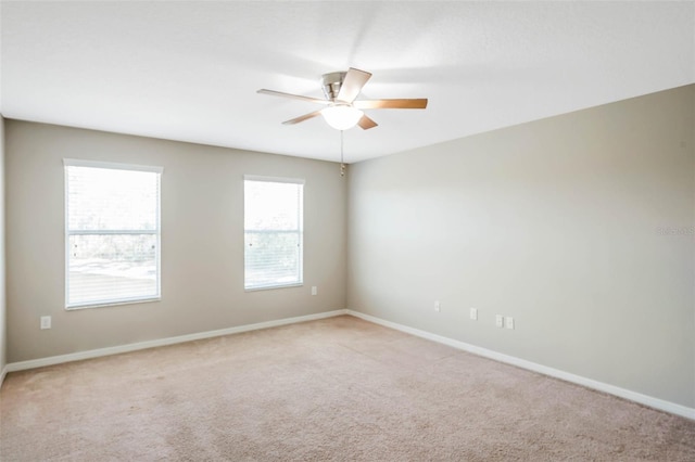 unfurnished room with light carpet and ceiling fan