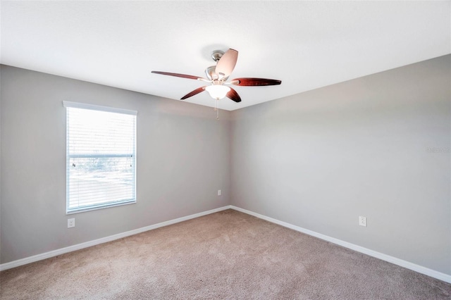 spare room with carpet and ceiling fan