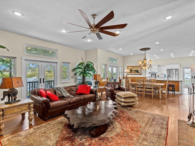 living room with hardwood / wood-style floors, plenty of natural light, french doors, and a textured ceiling