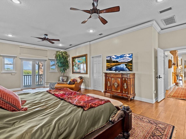 bedroom with ornamental molding, light hardwood / wood-style floors, access to outside, french doors, and ornate columns