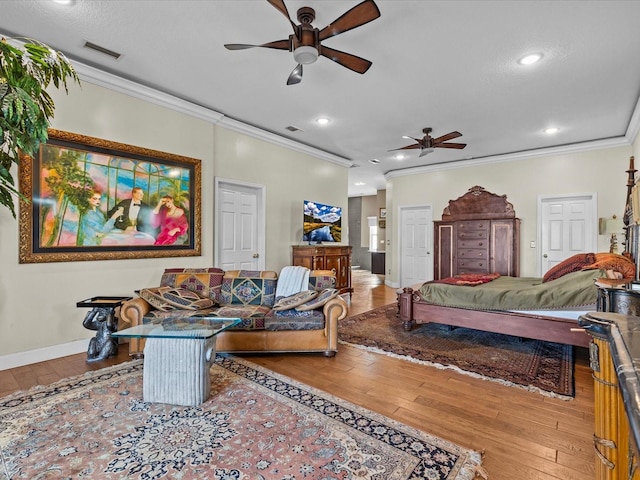 bedroom featuring hardwood / wood-style flooring, ceiling fan, and ornamental molding