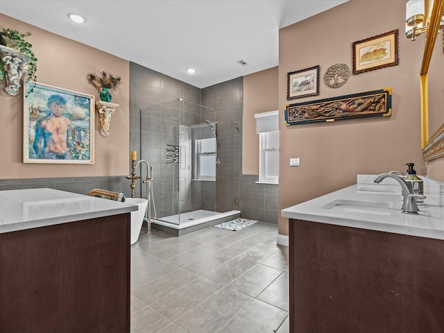 bathroom featuring vanity, tile patterned floors, plus walk in shower, and tile walls