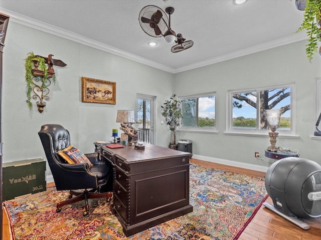 home office with ornamental molding and light hardwood / wood-style flooring