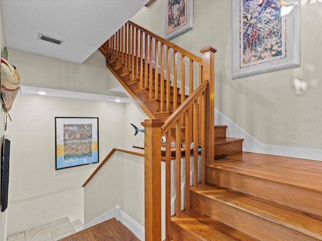 stairway with tile patterned floors