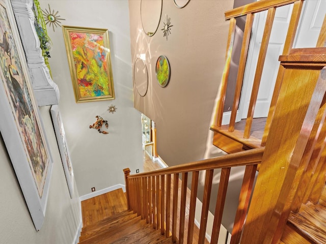 stairs featuring wood-type flooring