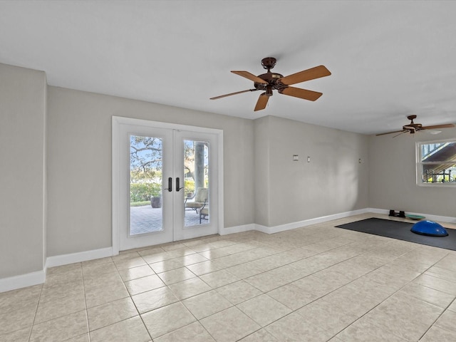 empty room with light tile patterned floors, ceiling fan, and french doors