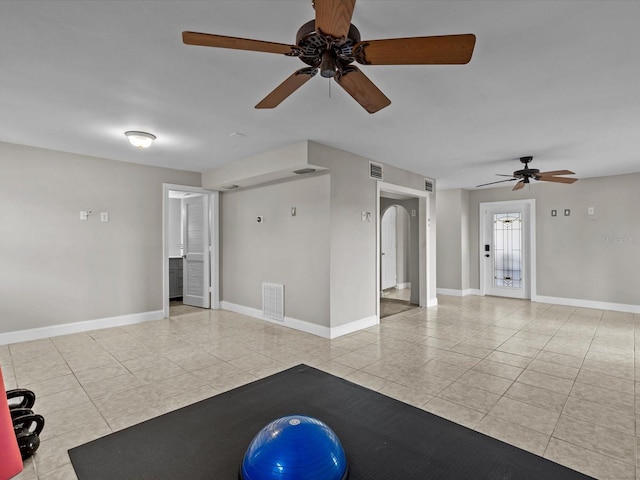 exercise room featuring light tile patterned floors