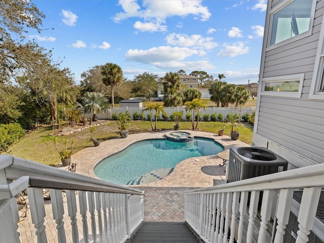 view of pool featuring an in ground hot tub and central AC