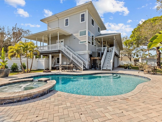 view of swimming pool with an in ground hot tub, a patio area, and cooling unit