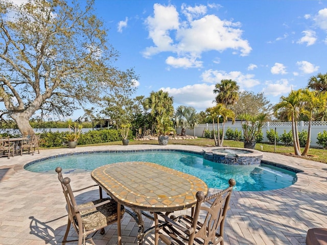 view of pool with an in ground hot tub and a patio