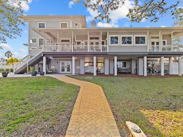 back of property featuring a yard and french doors