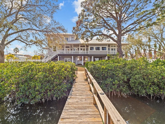 rear view of house featuring a water view