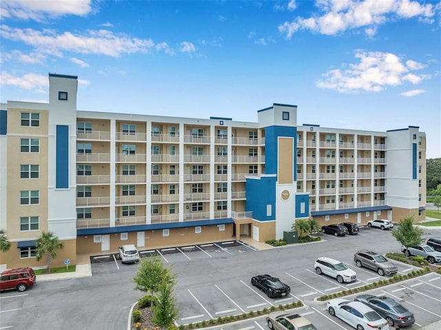 view of building exterior featuring uncovered parking