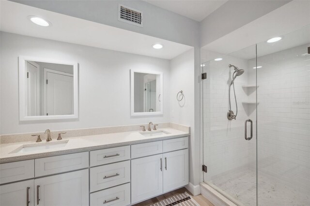 960 Starkey Rd Unit 10301, Largo, FL 33771 - bathroom featuring double vanity, a sink, visible vents, and a shower stall