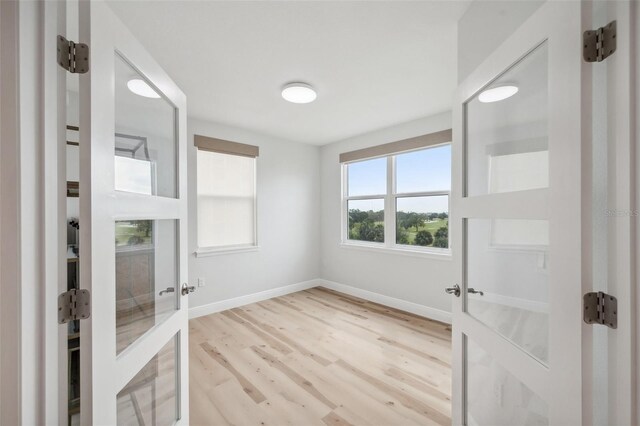 960 Starkey Rd Unit 10301, Largo, FL 33771 - entrance foyer featuring light wood-style floors, french doors, and baseboards