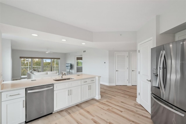 960 Starkey Rd Unit 10301, Largo, FL 33771 - kitchen featuring stainless steel appliances, white cabinets, light countertops, and a sink