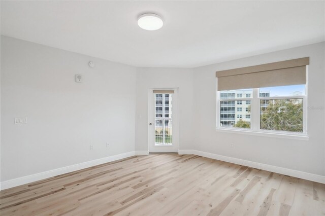 960 Starkey Rd Unit 10301, Largo, FL 33771 - spare room featuring light wood-style flooring and baseboards