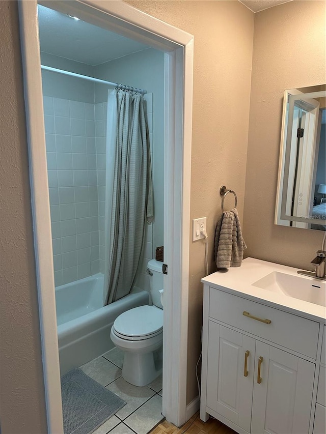 full bathroom featuring tile patterned flooring, vanity, shower / tub combo, and toilet