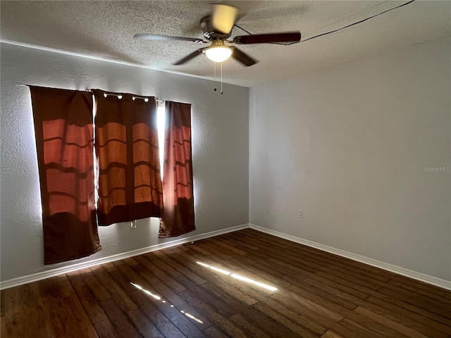 empty room featuring ceiling fan, hardwood / wood-style floors, and a textured ceiling