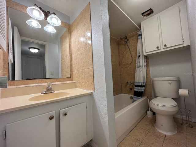 full bathroom with tile patterned floors, toilet, shower / bath combo with shower curtain, and vanity