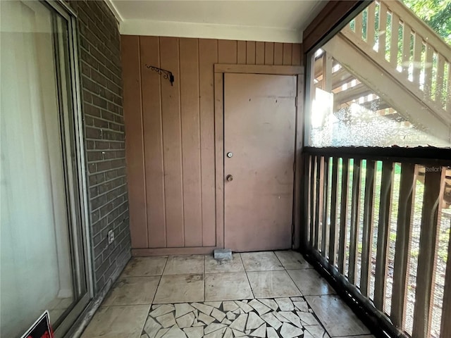 exterior space featuring wooden walls and brick wall