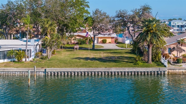 exterior space with a water view and a lawn