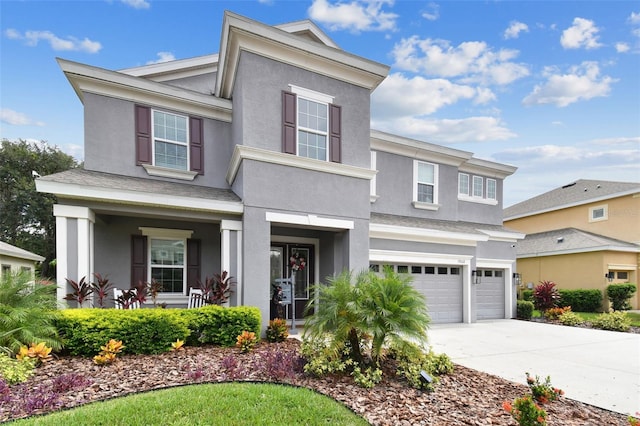 view of front of home featuring a garage and a porch