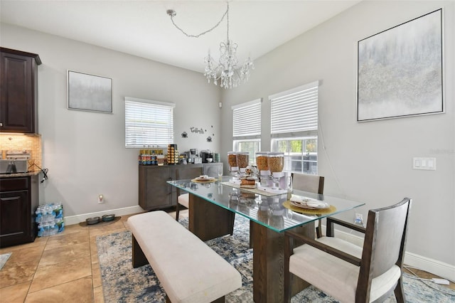 dining area featuring a notable chandelier and light tile patterned floors