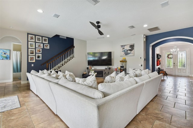 tiled living room featuring french doors and ceiling fan