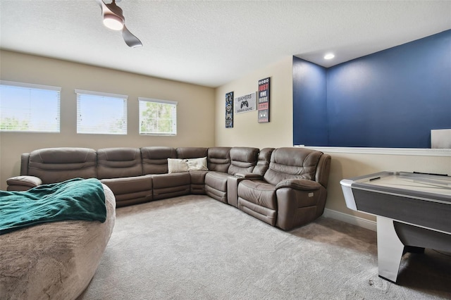 cinema room featuring carpet floors and a textured ceiling