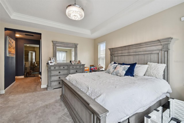 bedroom featuring crown molding, light carpet, a chandelier, and a tray ceiling