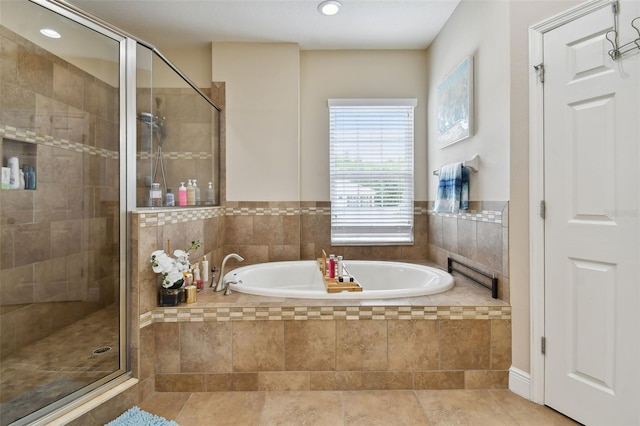 bathroom featuring tile patterned floors and shower with separate bathtub