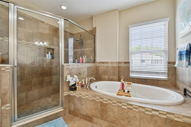 bathroom with tile patterned floors and separate shower and tub