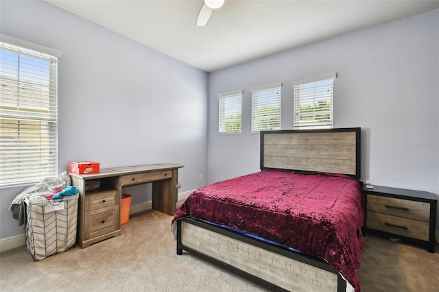 bedroom with ceiling fan and light carpet