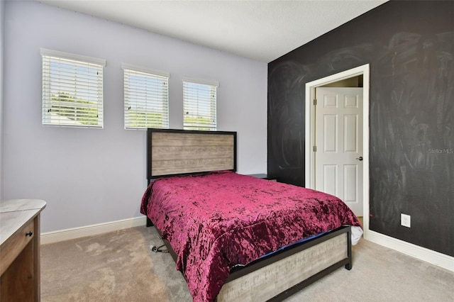 carpeted bedroom featuring multiple windows