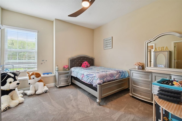 bedroom with ceiling fan and dark carpet