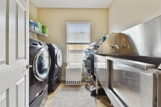 washroom with washing machine and clothes dryer