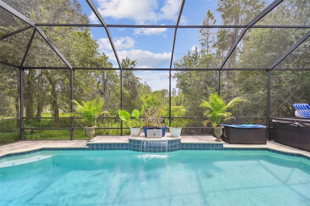 view of pool with a hot tub and glass enclosure