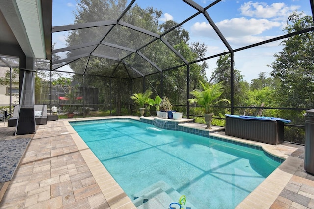 view of pool featuring a patio area, pool water feature, and glass enclosure