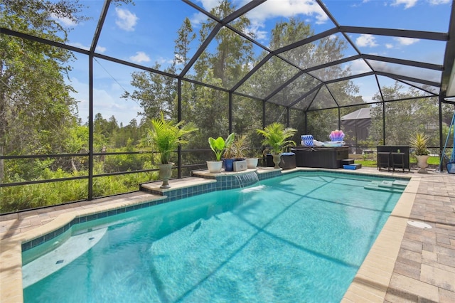 view of swimming pool featuring a patio area, a hot tub, pool water feature, and glass enclosure