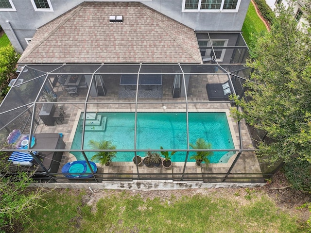 view of swimming pool with a lanai