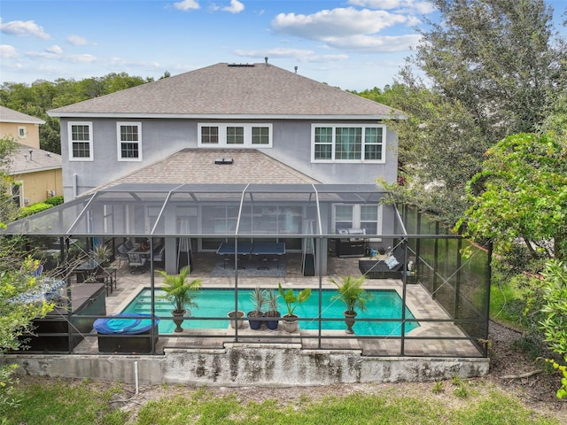 rear view of property with a fenced in pool, a patio, and glass enclosure